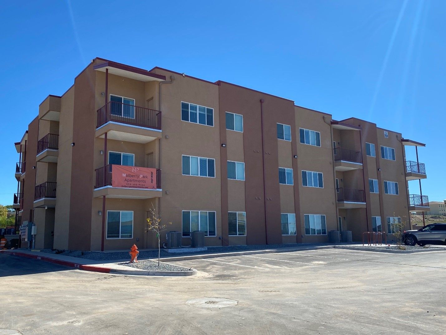 A picture of the apartments with the parking area